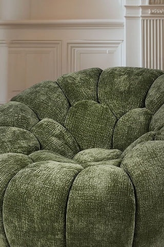 A close up detail of the green snug armchair showing the texture of the legless chair.