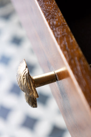 Close-up of the Mushroom Knob - Gold styled on an open drawer, seen from above.