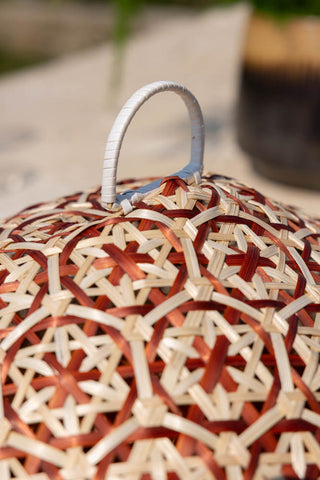 Close-up of the handle on the Natural Bamboo & Red Floral Detail Food Cover.