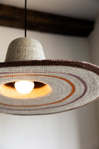 Detail shot of the illuminated Natural Seagrass Ceiling Light, seen from below.