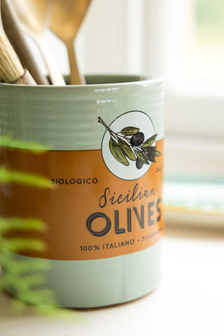 Side view of the beautiful orange band on the pot with the words 'biologico, sicilian olives''