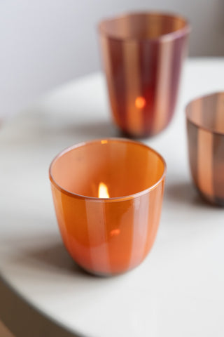 Close-up of the Orange & Pink Tones Striped Tealight Holder - Short, with two other versions in the background.