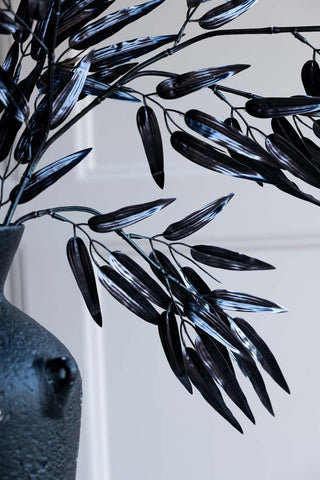 Detail shot of the Ornamental Bamboo In Black displayed in a vase.