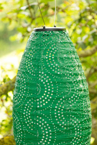 Detail shot of the Oval Shaped Green Outdoor Garden Lantern hanging from a tree.