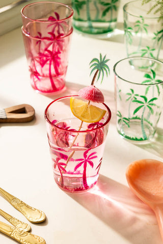 The Palm Tree Party Toothpicks with a slice of lemon on, styled in a glass.