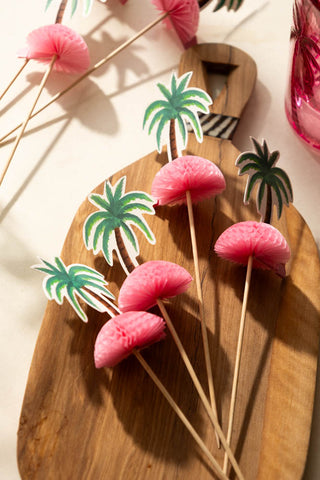 The Palm Tree Party Toothpicks displayed on a wooden serving board.