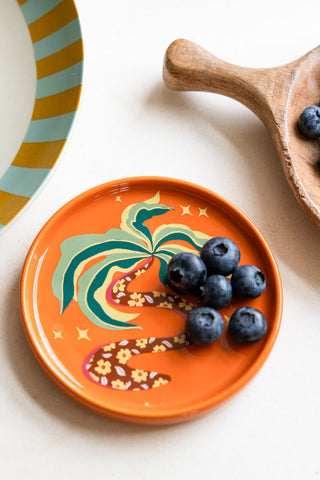 The Palm Tree Small Side Plate styled on a white counter top with blueberries on top.