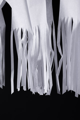 Close-up of the fringing on the Paper Ghost Halloween Garland.