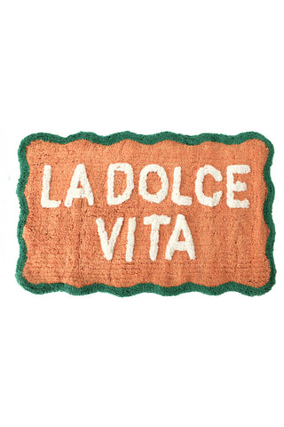 Cutout of the Peach La Dolce Vita Bath Mat on a white background.