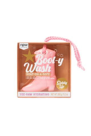 Cutout of the Pink Cowboy Boot Soap On A Rope in the packaging, on a white background.