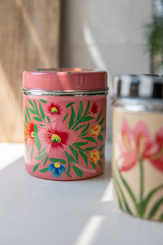 The Pink Floral Spice Tin styled with another tin and a chopping board.