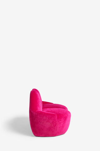 The Pink Lips Sofa on a white background, seen from the side.