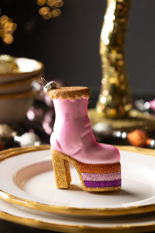 A close up image of The Pink Glass Heeled Boot Christmas Tree Decoration styled Christmas table setting