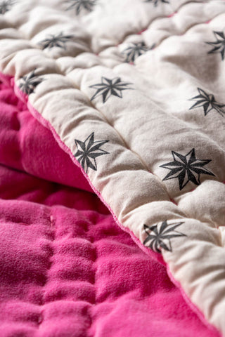 Close-up of the star motif on the Reversible Hot Pink Star Throw.