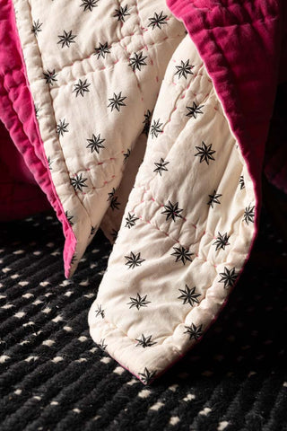 Close-up of the Reversible Hot Pink Star Throw showing the star motif.