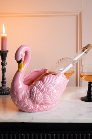 Pink Swan Display Bowl used as a wine holder with candle in background