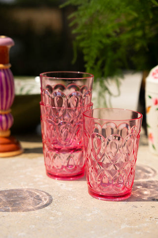 Three of the Pretty Embossed Pink Water Tumbler styled together on an outdoor summer table.