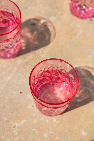 An overhead shot of the Pretty Embossed Pink Water Tumbler styled on an outdoor table.