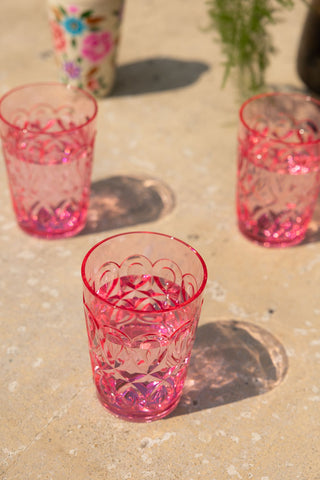 The Pretty Embossed Pink Water Tumbler with shadows from sunlight