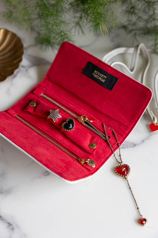 The Queen of Hearts Playing Card Jewellery Case open with jewellery inside, styled on a white marble surface with a trinket tray and plant.