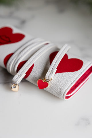 Close-up of the Queen of Hearts Playing Card Jewellery Case, showing the heart details on the end of the ties.