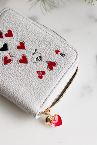 Close-up of the Queen of Hearts Playing Card Purse on a white surface.