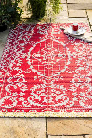 Reversible red floral garden rug, made from recycled plastic and easy to clean.