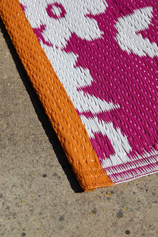 Detail shot of the Recycled Vintage Design Outdoor Rug in Pink.