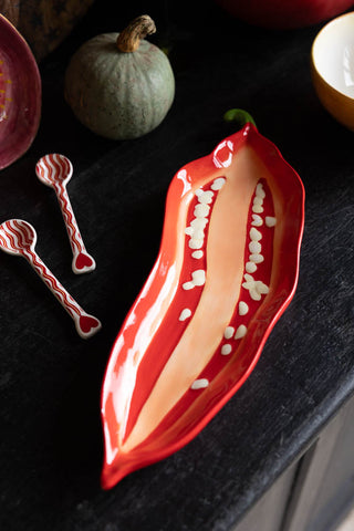 Red chilli serving plate on a dark autumn styled table