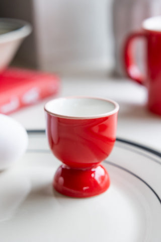 An empty red egg cup 