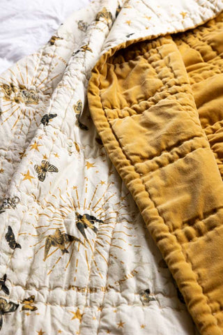 Detail shot of the design of the Reversible Gold Rock & Rose Throw.