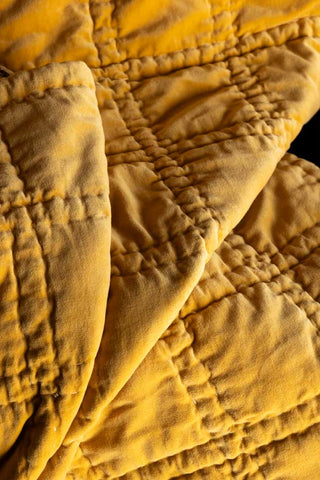 Detail shot of the gold side of the Reversible Gold Rock & Rose Throw.