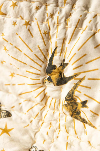 Close-up of the bird motif on the Reversible Gold Rock & Rose Throw.