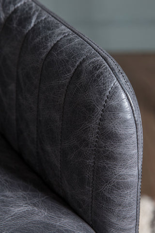 Detail shot of the arm of the Ribbed Antique-Style Black Leather Swivel Chair.