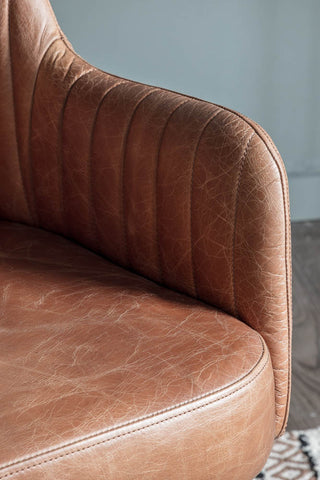 Close-up of the arm of the Ribbed Antique-Style Brown Leather Swivel Chair.