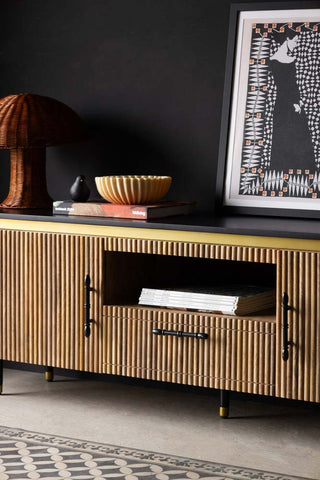 Close-up of the centre of the Ribbed TV Unit, with magazines on the shelf and other decorative accessories on the top.