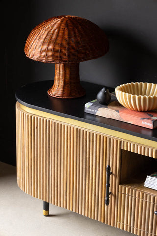 Close-up of one side of the Ribbed TV Unit, styled with a lamp, book, bowl and ornament.