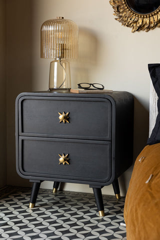 The Ringo Bedside Table styled next to a bed, with a book, glasses and table lamp on.