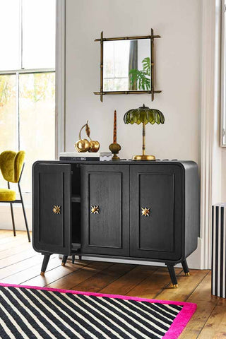 The Ringo Sideboard styled in a living room with various home accessories.