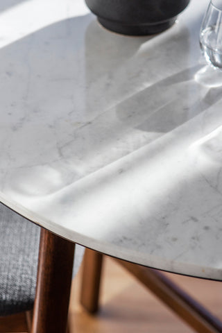 Close-up image of the Round Acacia & Marble Dining Table.