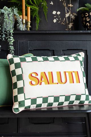 The Saluti Cushion on a bench with another cushion displayed in front of a black sideboard.