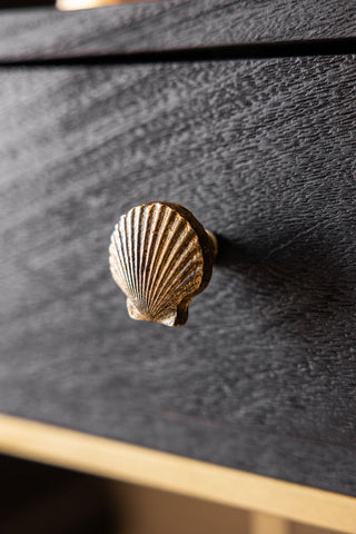The Scallop Knob - Gold shown on a drawer.