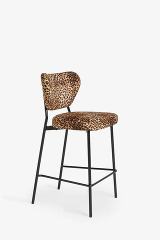 One of the Set Of 2 Bar Stools in Leopard Print Velvet on a whit background, seen from a side angle.