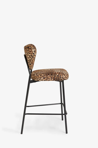 One of the Set Of 2 Bar Stools in Leopard Print Velvet seen from the side, on a white background.