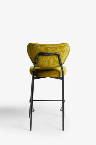 One of the Set Of 2 Bar Stools in Needlecord Velvet Green seen from the back, on a white bakground.