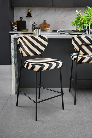 The Set Of 2 Bar Stools in Stripe Velvet styled in a kitchen next to a kitchen island.