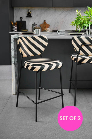 Black and white bar stools in a modern kitchen setting.