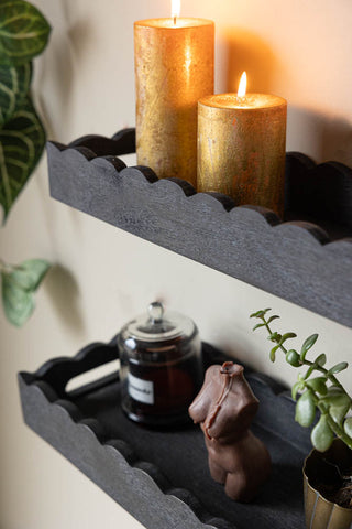 Close-up of the Set Of 2 Black Wooden Scalloped Wall Shelves displayed on the wall, showing the shape of the front of the shelves