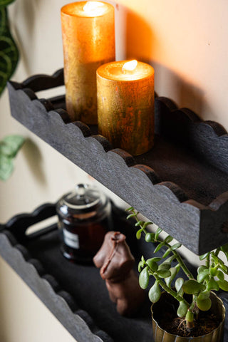 The Set Of 2 Black Wooden Scalloped Wall Shelves captured from above to show the tray shape