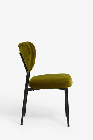 One of the Set Of 2 Dining Chairs In Needlecord Velvet Green, seen from the side, in front of a white background.